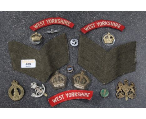 Tin of cap badges, cloth badges, etc. Canadian Forestry Corps, Durham Light Infantry, West Yorkshire Regiment, etc. 