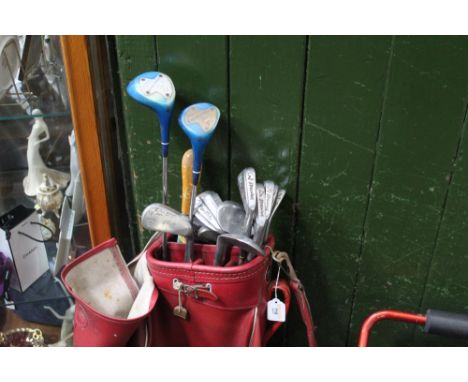 A collection of spalding top-flite vintage golf clubs in red leather golf bag
