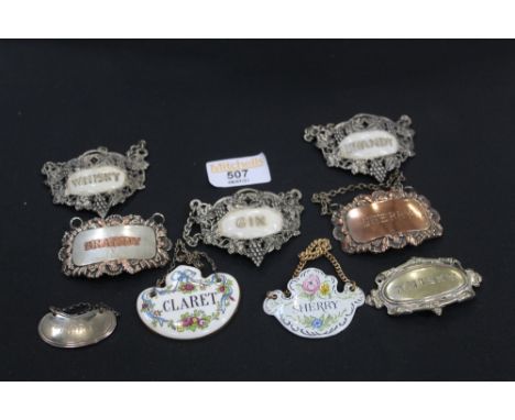 Decanter labels, one silver, the others enamelled or plated