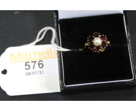 A 9 ct gold garnet and pearl daisy cluster ring, Size K