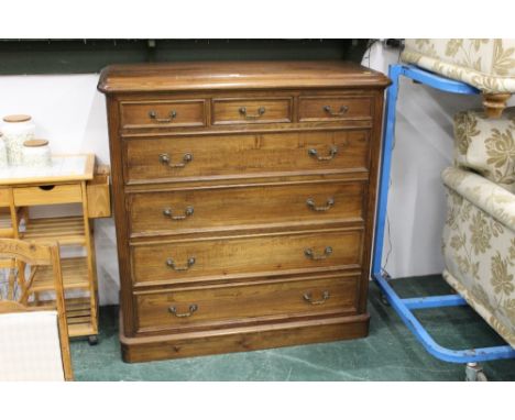 A reproduction oak chest of three short and four long cockbeaded drawers, 126 cm high, 120 cm wide