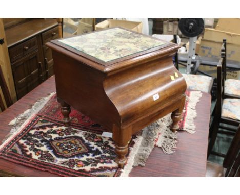 A Victorian mahogany commode with glass top and turned legs