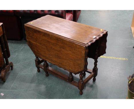 An oak drop leaf and gate leg table with barley twist supports