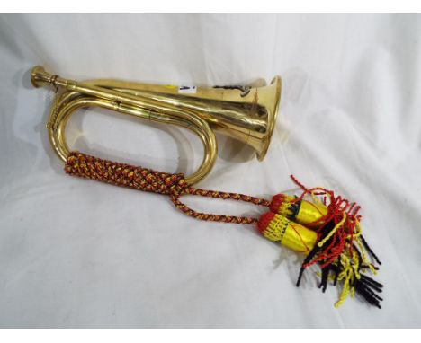 A yellow metal bugle displaying an army crest Est £20 - £40