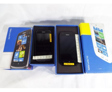 An unused Nokia Lumia 610 mobile phone with battery and manual, boxed and an unused Nokia Lumia 710 with manual, card cover a