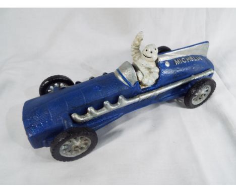 A cast iron model depicting a blue Hubley 1934 racing car driven by the Michelin Man, approx 25 cm (length) - Est £20 - £40