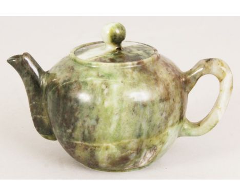 A CHINESE JADE LIKE HARDSTONE TEAPOT & COVER, the predominantly green stone with lighter and darker striations, 5.75in long i