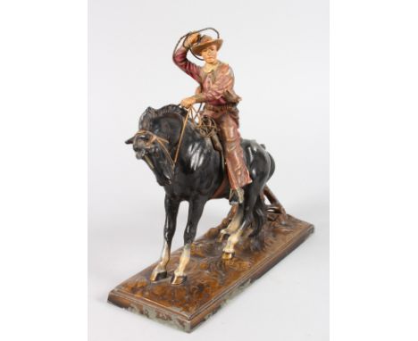 AN AUSTRIAN PAINTED METAL AMUSING NOVELTY LIGHTER, a cowboy on a horse.  9ins high.