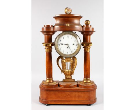 AN EARLY 19TH CENTURY AUSTRIAN PORTICO CLOCK, with circular white enamel dial, black numbers, column supports and gilt lyre. 