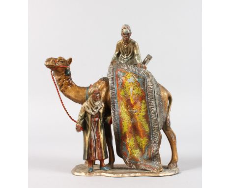 AN AUSTRIAN PAINTED METAL ARAB GROUP LIGHTER, two men with a camel. 7ins high.