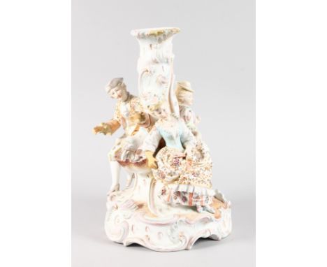 A LARGE 19TH CENTURY FRENCH PORCELAIN LAMP. with a gallant and two ladies sitting around a fountain. 37cms high.