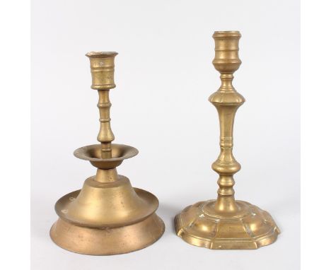 AN EARLY BRASS PETAL BASE CANDLESTICK, 9ins high, and another with stepped circular base, 8.5ins high. (2).