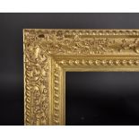 20th Century Italian School. A Carved Giltwood Frame, with swept centres and corners, 37.5" x 23.