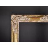 20th Century Continental School. A Gilt Composition Frame, with swept and pierced centres and