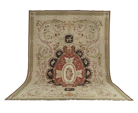 A monumental Aubusson carpet19th centuryOn light sandy ground, filled with spiralling tendrils in pink and green, the central