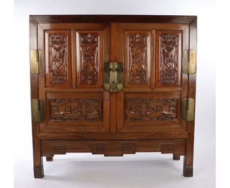 Chinese Huanghuali cabinet, the rectangular top above a pair of carved panel doors with flowers and birds above scroll carved