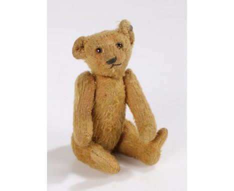 Early 20th Century Steiff bear, of small proportions, the mohair bear with moveable head, arms and legs, Steiff button to the