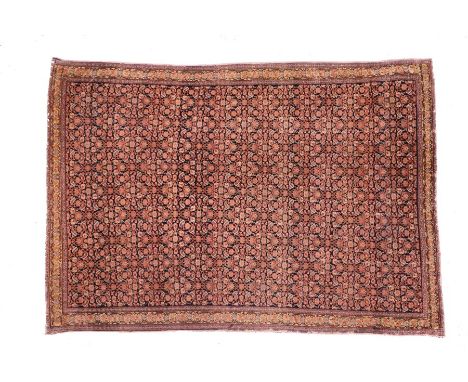 Persian Qum part silk Dozar carpet, the blue ground with rows of red flowers and a yellow foliate edge, 140cm x 194cm