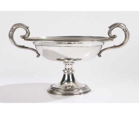 Swiss silver dish, with twin acanthus leaf capped scrolled handles above the beaded rim and engine turned frieze, raised on a