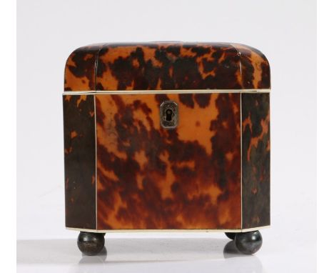Regency period tortoiseshell tea caddy, of shaped octagonal form with ivory stringing and four metallic ball feet, the hinged