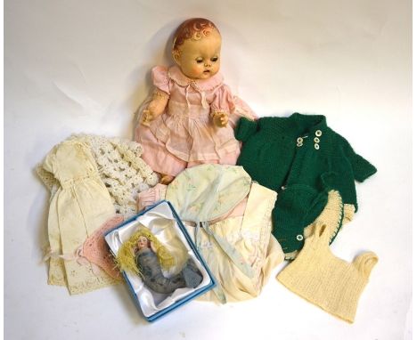 A 1940s Pedigree hand plastic doll to/w a collection of vintage doll's clothes, a small Continental ceramic doll dressed as a