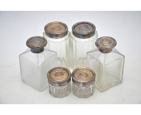 Three pairs of Victorian cut glass toilet bottles and jars with chased and engraved silver tops, William Neal, London 1867Two