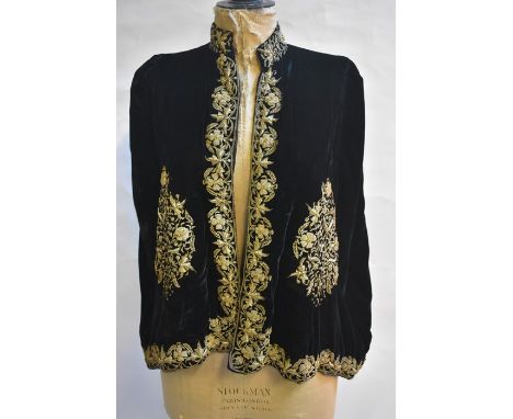 A vintage black silk velvet evening cape heavily embroidered with metallised thread and silk lined, a 1920s evening jacket wi