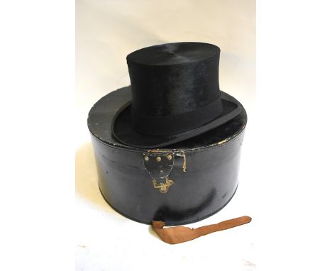 A vintage black silk top hat, retailed by Dunn & Co. hat makers, London, 55 cm circ. x 20 cm front to back x 16 cm across, to