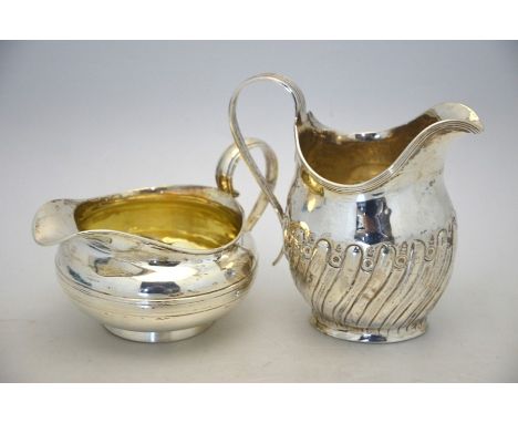 A Georgian IV silver milk jug of compressed melon form with moulded waist and tapering foot rim, Joseph Angell I, London 1829