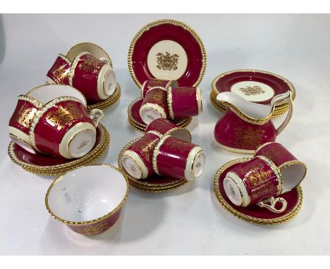 A Spode tea and coffee service, pattern&nbsp;47309, puce ground, gilt moulded border and central armorial with motto 'My Trus