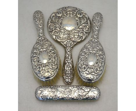 An embossed silver-back three piece brush set including hand mirror, Birmingham 1958 to/w a silver-backed clothes brush embos
