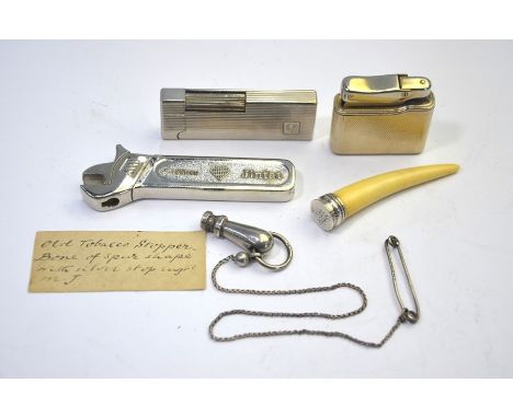 An antique bone pipe-tamper with spur handle and white metal end, to/w an Edwardian silver pipe-tamper Birmingham 1901, a Cal