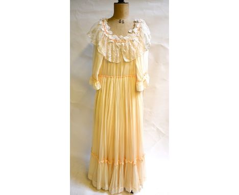 A 1980s bespoke pale peach silk chiffon wedding dress with silk underskirt with deep antique needle-run lace trim to neckline