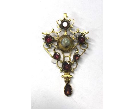 An Arts and Crafts yellow gold brooch of scroll foliate design set with central bossed pearl and five circular amethysts, wit