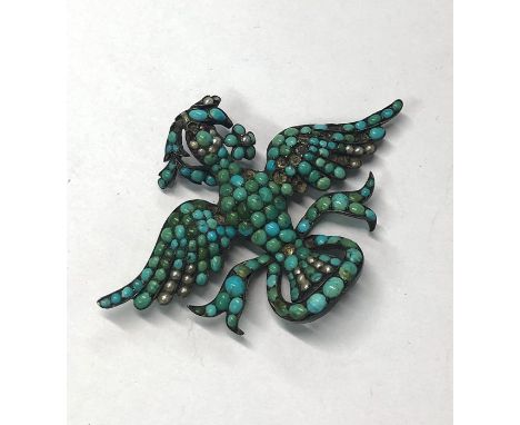 A Victorian silver set brooch in the form of a dove of peace with outstretched wings, carrying an olive branch in its beak, w