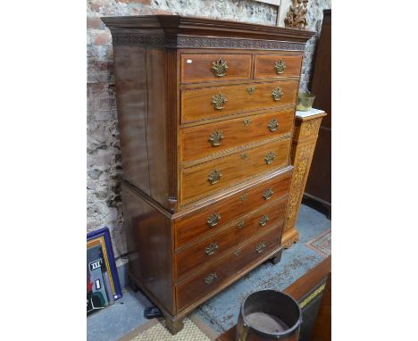 A Georgian cross banded chest on chest, the pediment over a blind fret cut frieze, two short over six long drawers (handles r