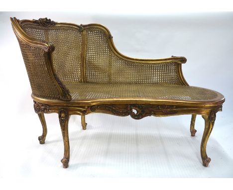 A Louis XV style giltwood framed bergere salon sofa, 140 cm long x 93 cm h o/a (the seat 44 cm h), early 20th centuryAll cane