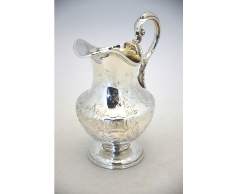 A Victorian Irish silver baluster milk jug with scroll handle and engraved rococo decoration, on domed foot, Robert Smith, Du