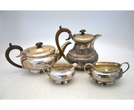 A silver four piece tea service of bulbous oval form, with milled rims and flared foot, composite handles, J.B. Chatterley &a
