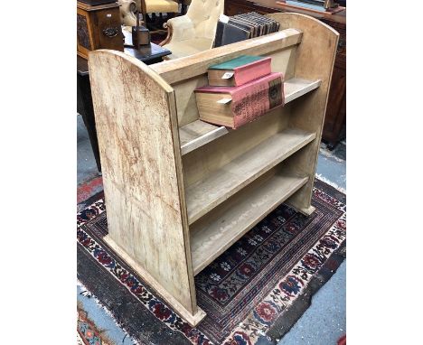 A vintage limed oak library book carrier, with three back to back graduated open shelves, on castors, 92 long x 66 cm x 107 c