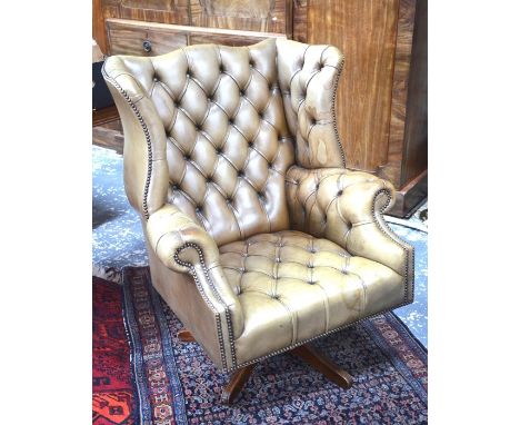 A vintage buttoned tan leather armchair to/w a matching footstool (2)&nbsp;