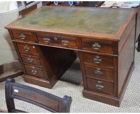 A late Victorian twin pedestal mahogany desk, the green &nbsp;tooled leather top over an arrangement of nine drawers, stamped