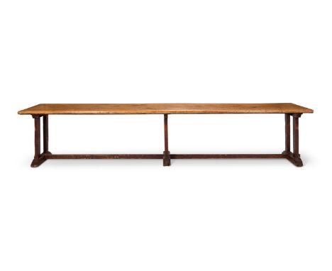 AN OAK TRESTLE TABLE  19TH CENTURY, POSSIBLY INCORPORATING EARLIER ELEMENTS  The plank top above end supports united by stret
