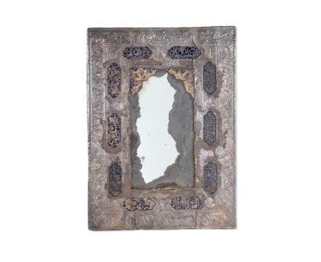 A MOORISH SILVER METAL FRAMED MIRROR CIRCA 1900 with blue enamel vignettes inscribed with Islamic calligraphy 44cm high, 32cm