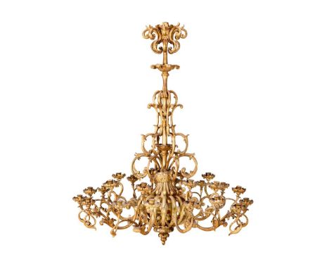 A LARGE ITALIAN BAROQUE GILTWOOD TWENTY FOUR LIGHT CHANDELIER  18TH CENTURY  With eight scrolling branches each supporting th