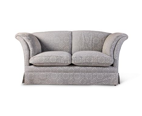 AN EDWARDIAN WALNUT `PORTARLINGTON' SOFA  EARLY 20TH CENTURY, BY HOWARD & SONS With out-turned arms and loose cushions, on tu
