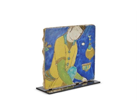 A SAFAVID TILE  PERSIA, 17TH CENTURY depicting a kneeling courtier at a feast in the Cuerda Seca technique  23.5cm high, 25.5