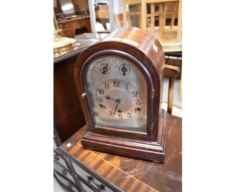 A early 20th Century bracket clock having mahogany arch case, westminster chime movement and silvered dial, engraved to movem