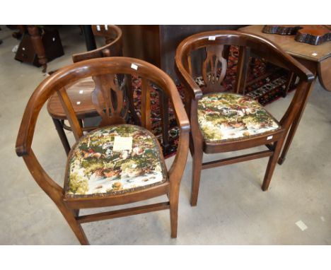 A pair of early 20th Century elbow chairs having hunting themed upholstery