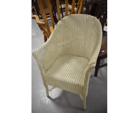 A vintage Lloyd loom tub chair in cream